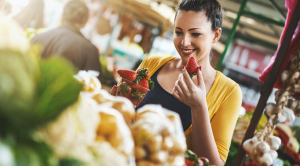 British Food and Drink Fortnight woman smiling eating strawberry